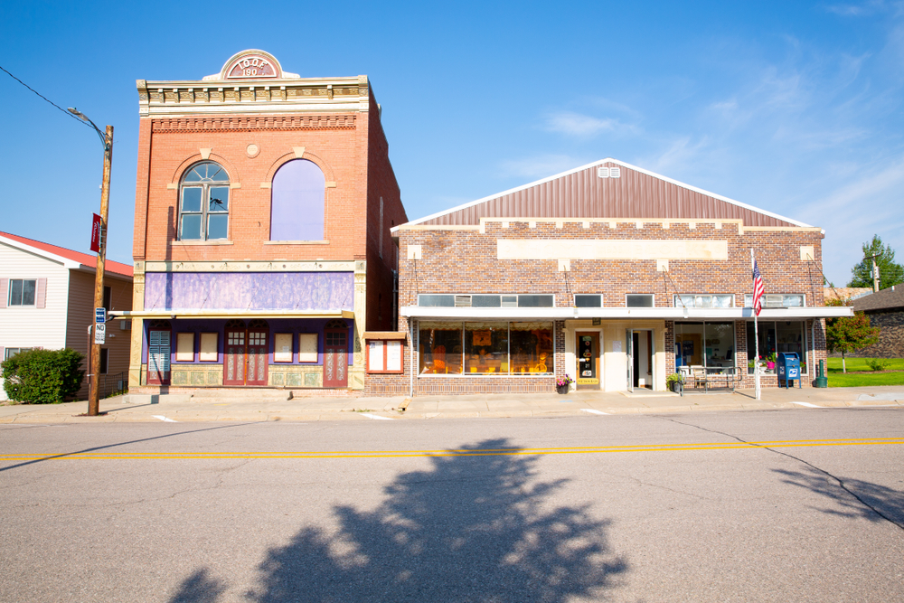 Two historic buildings on a street in Harrison Nebraska on a sunny day. 