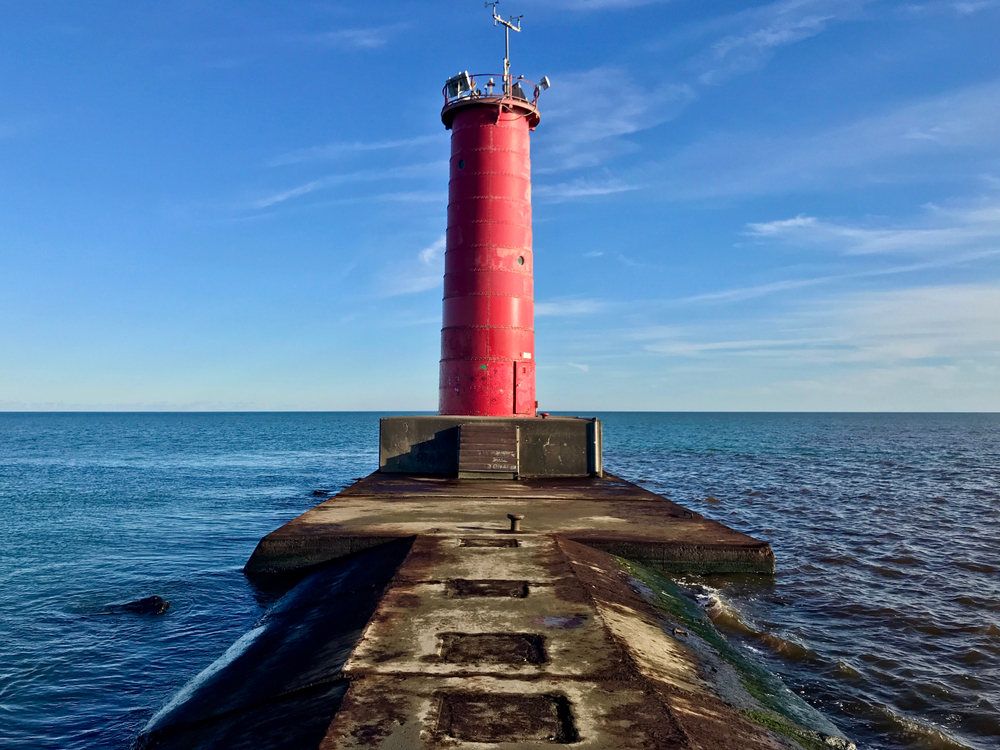 A red lighthouse at the end of  the breakwater wall. One of the lighthouses in Wisconsin. 