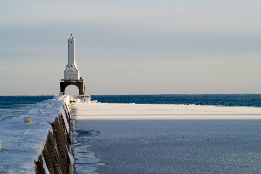 Port Washington Breakwater Light. This unusal white lighthouse is out at the end of the breakwater wall and is seen in the snow.  
