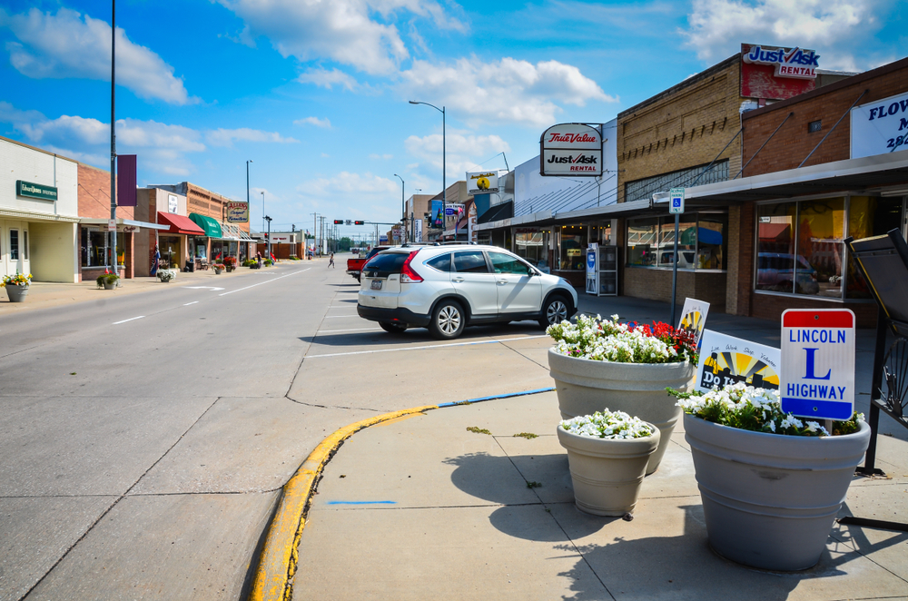 A main street in one of the towns in Nebraska where there are shops on a sunny day. 