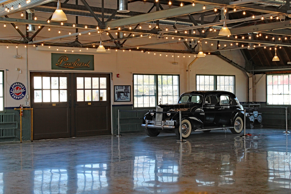 A Packard car on display in what looks to be an old car dealership. 