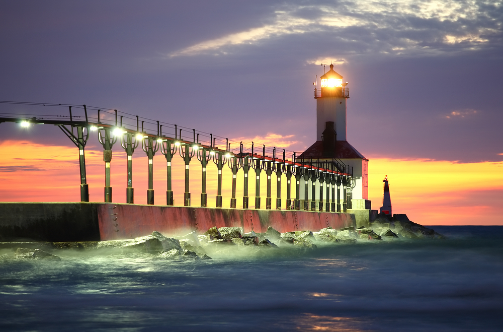 Lighthouse at sunset with yellow sky at dusk one of the best things to do in Indiana