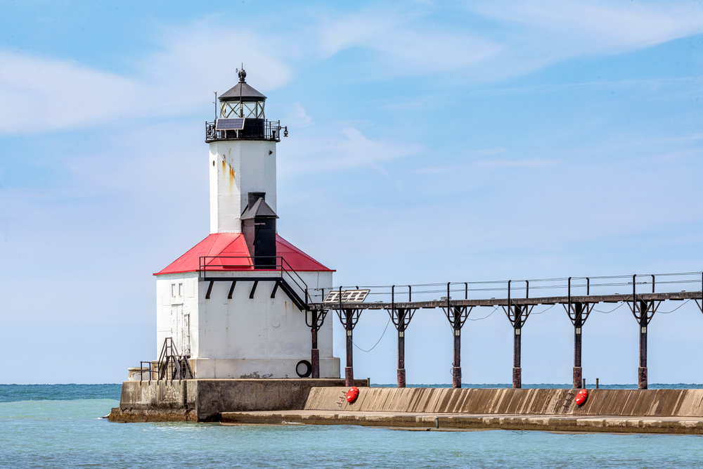 With its elevated catwalk, the East Pierhead Light, a historic lighthouse on Lake Michigan, marks the entrance to the harbor at Michigan City, Indiana. The article is about things to do in Michigan city 