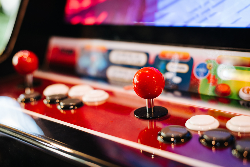 Close up of a control stick on an arcade console.