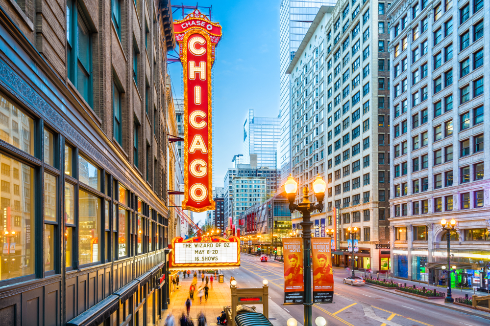 Side view of the iconic Chicago Theater sign and marquee lit up at blue hour.