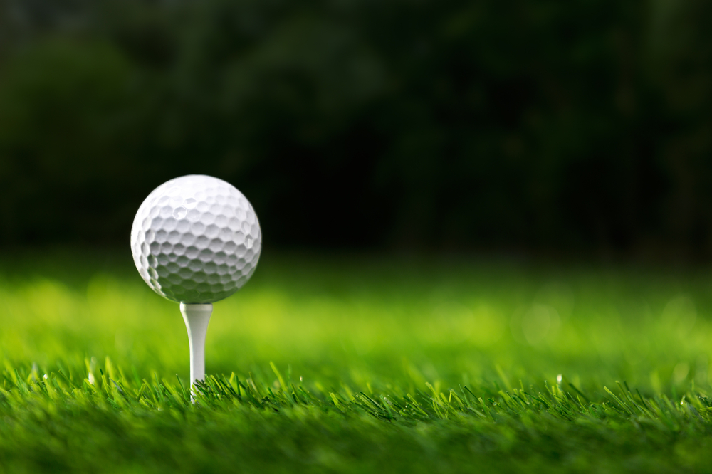 Close up of a golf ball on a tee.