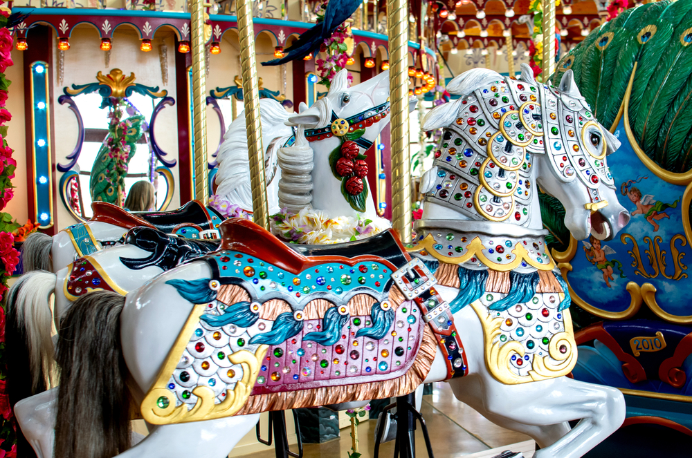 One of the white horses on the Silver Beach Carousel with many colorful stones.