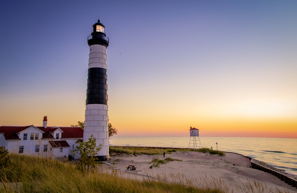 Big Sable Lighthouse on the sandy coast of Lake Michigan at sunset. Ludington State Park in Ludington, Michigan.