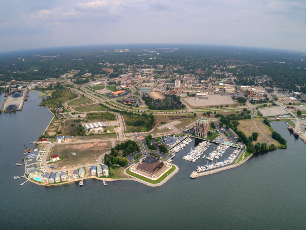 Aerial view of Muskegon showing the harbor, buildings and town