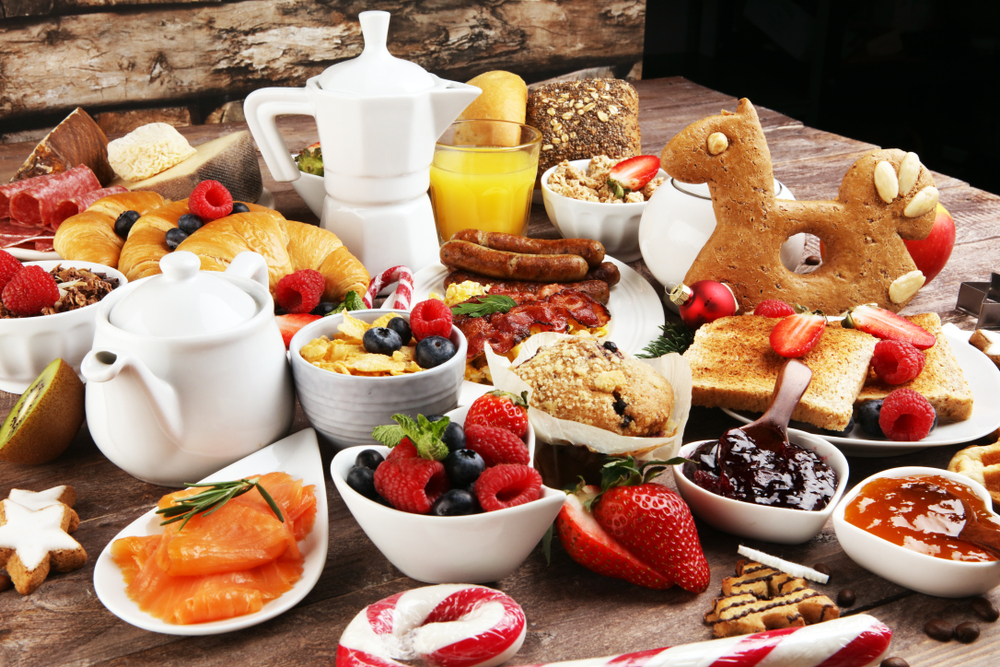 A large Christmas breakfast spread with toast, candy canes, fruit, and more.