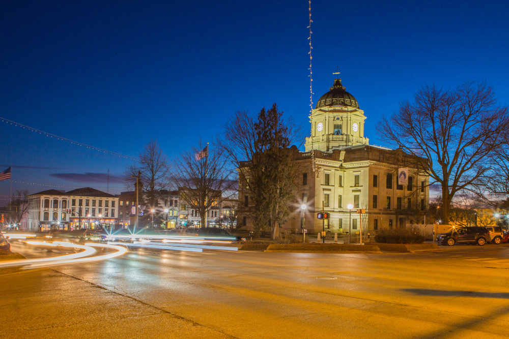 Downtown Bloomington at Twilight. You can see historic buildings and light trails from cars on the road. 