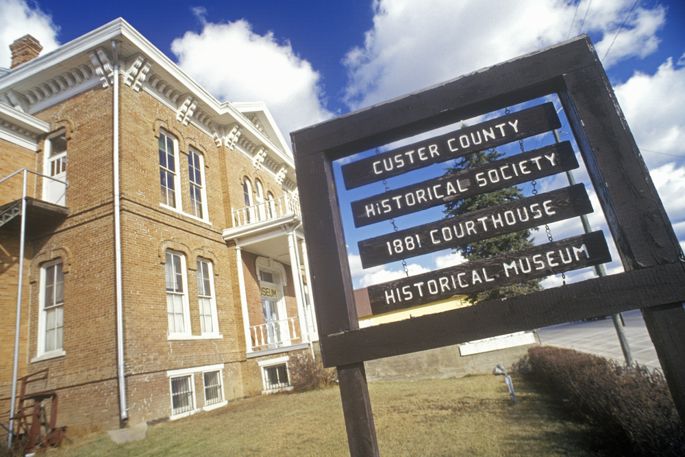 Custer County Historical Society with 1881 Court House in Custer, SD. The picture shows the builsing and the sign. It's one of the things to do in custer sd. 