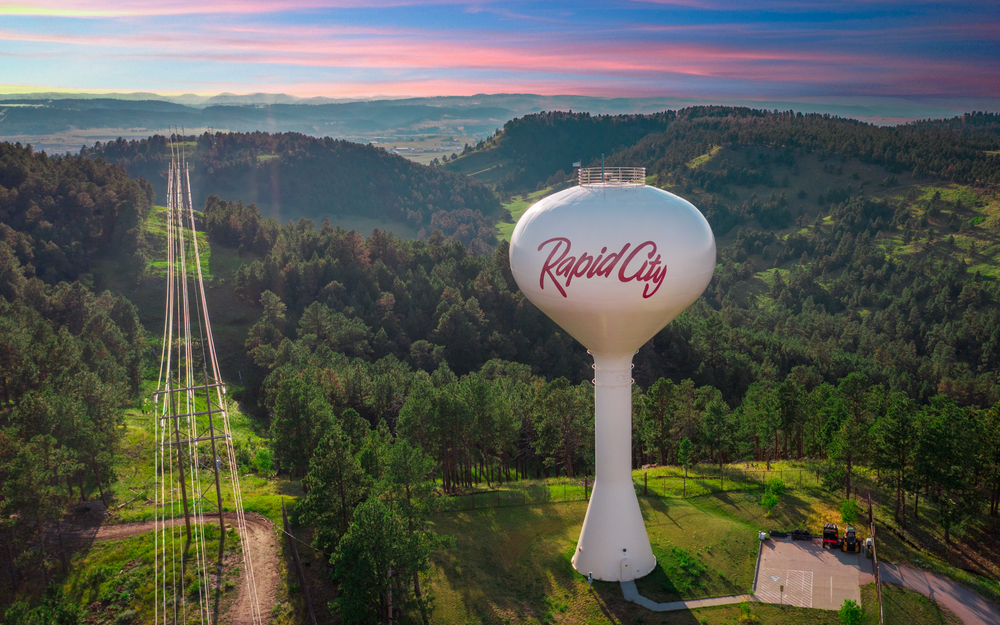 Rapid City Water tover with greenary all around and hills in the background. The article is about things to do in Rapid City