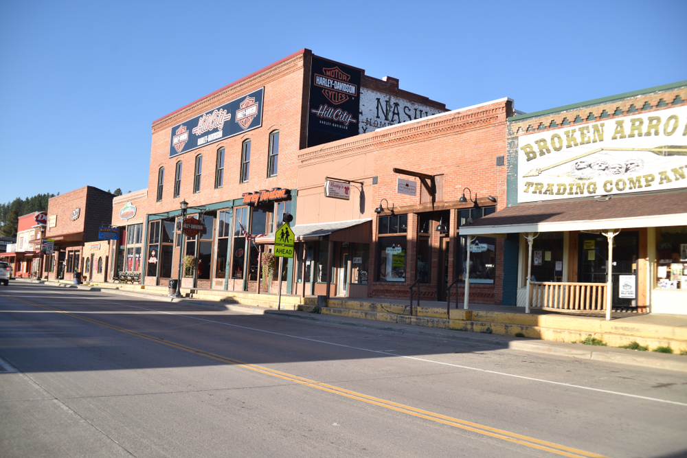 Main street Hill City.  There are restaurants, shops and bars lining the street. 