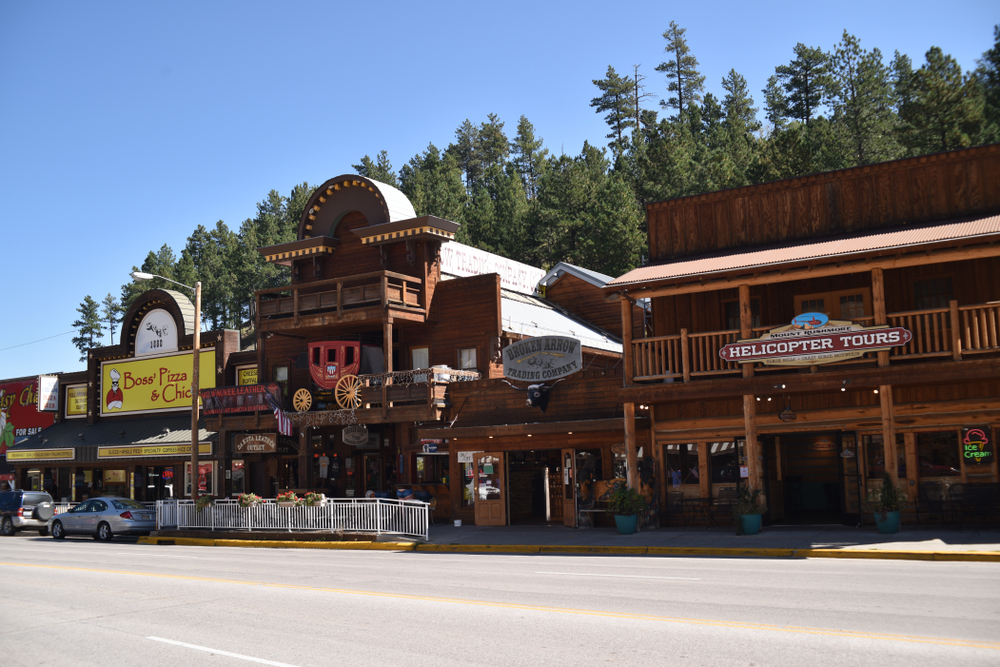 Main street Keystone, S.D. filled with boutiques, gift shops, fine dining, lodging and history. The buildings look like log cabins.  Keystone is a town in South Dakota 