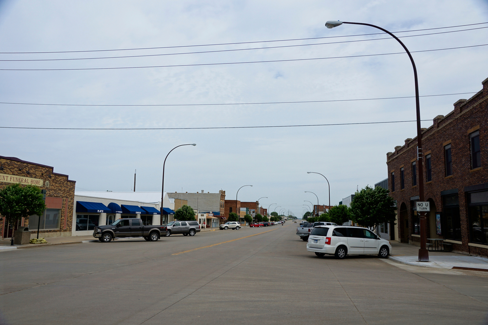  Downtown Platte in South Dakota showing the shops and cars parked on the road. 