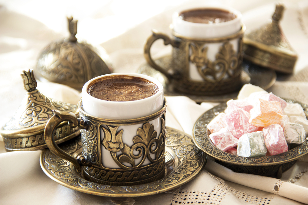 Turkish coffee in ornate silver and porcelain mugs and a sweet Turkish desert that is cubes of pink, green, and orange. It's similar to what you'll find at one of the restaurants in Bloomington.