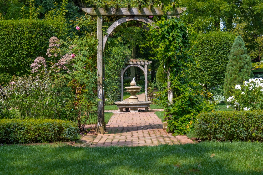 a well-decorated garden with pink flowers and fountain things to do in dubuque