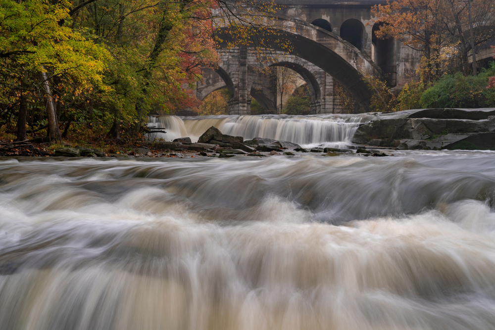 waterfalls with a stone bridge in the background columbus to cleveland