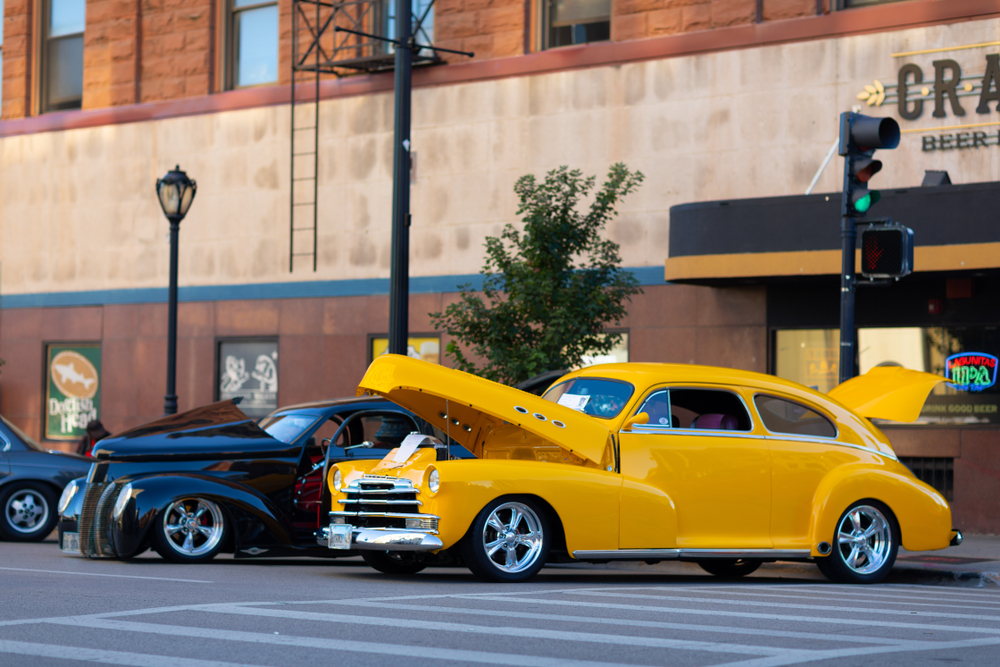 A bright yellow 1948 Chevrolet Fleetline parked in downtown Springfield.