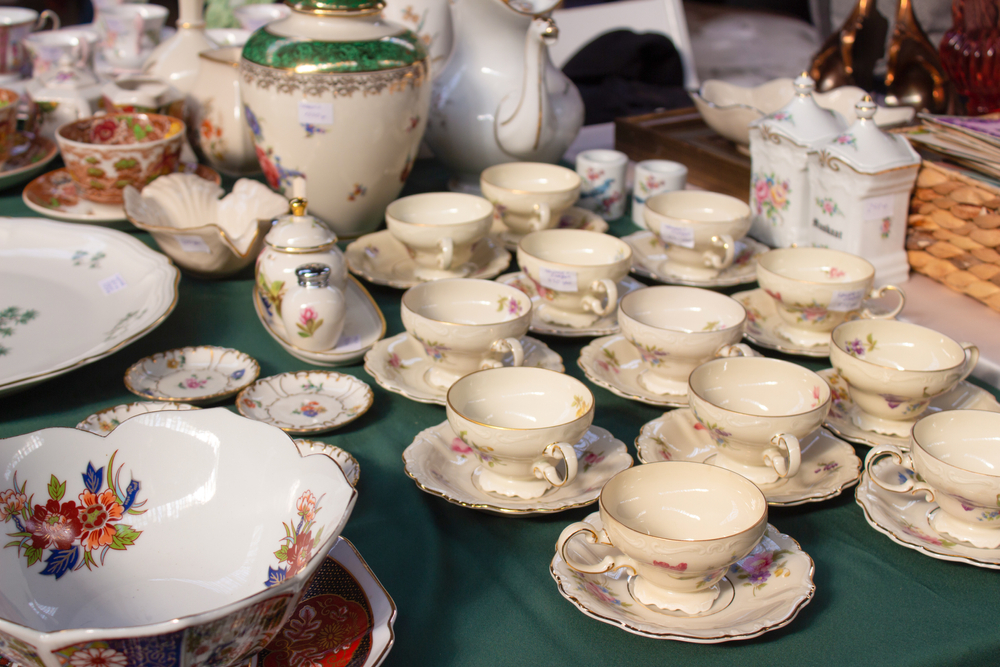 antique crockery on a table Cups and saucers are laid out on the table. 