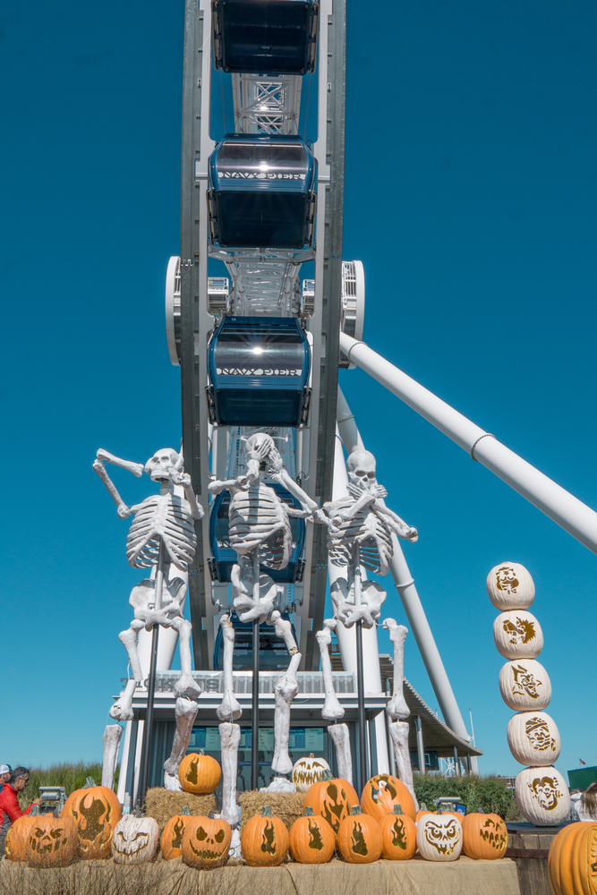 Giant skeletons, jack-o-lanterns, and the Ferris wheel at the Navy Pier in the fall in Chicago. 