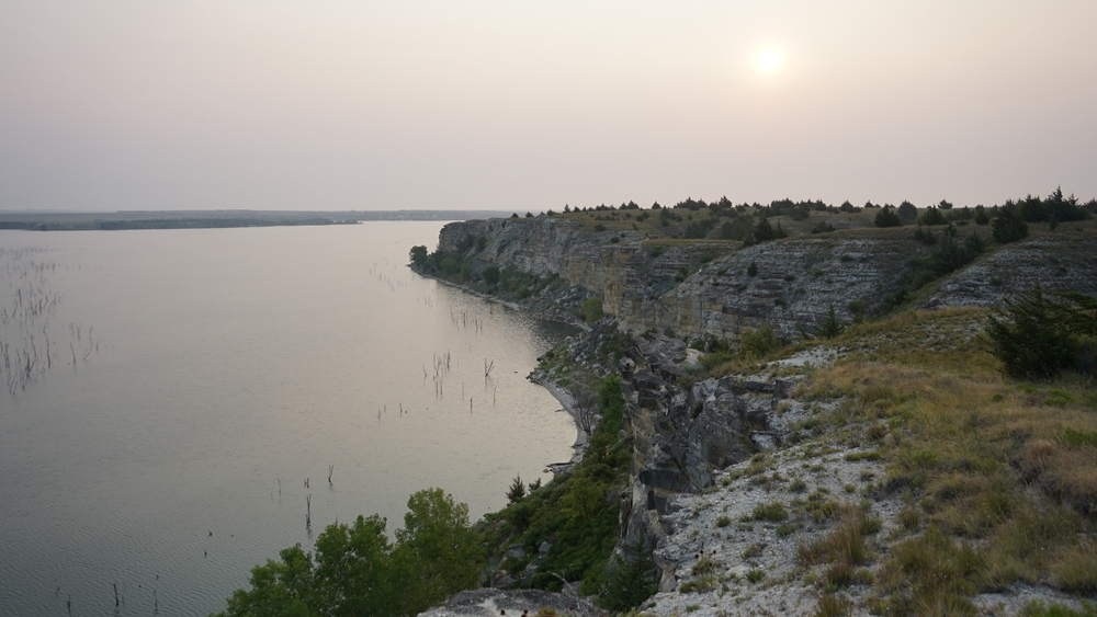 Hazy sky over Cedar Bluff State Park featuring the lake and rugged cliffs.