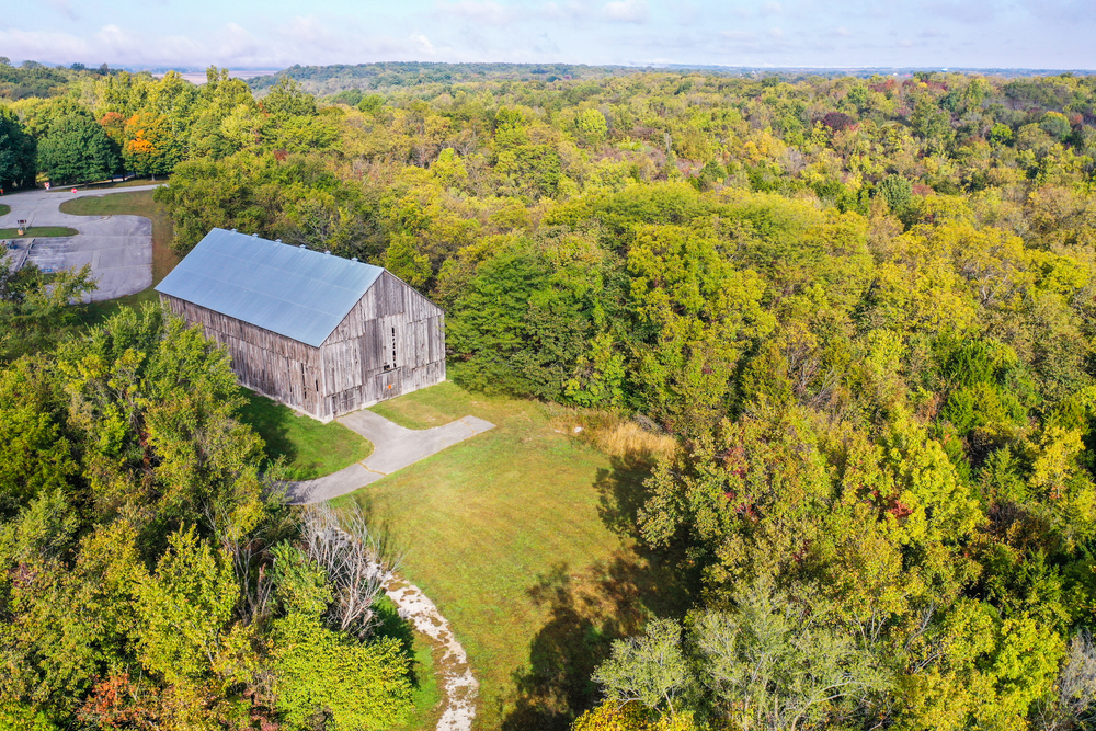 Aerial view of a historic house surrounded by trees turning fall colors fall in kansas