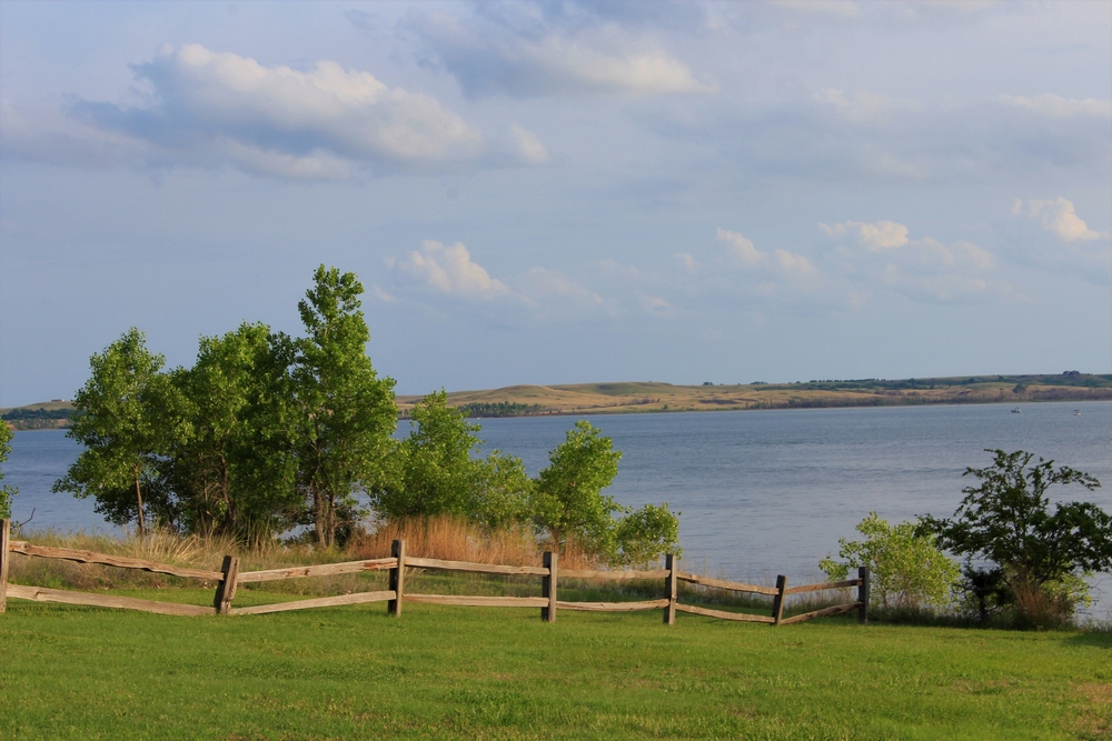 View of Kanopolis Lake with a fence in the foreground.