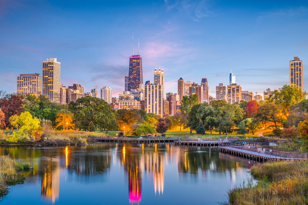 Sunset photo over a pond in Lincoln Park looking towards downtown Chicago.