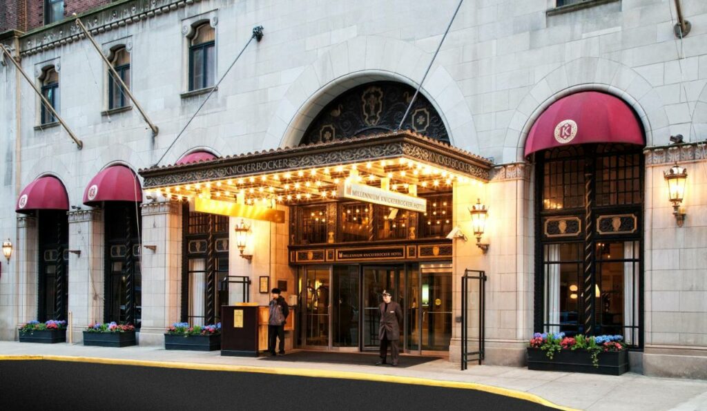 Entrance to the Millennium Knickerbocker Chicago with lit marquee.