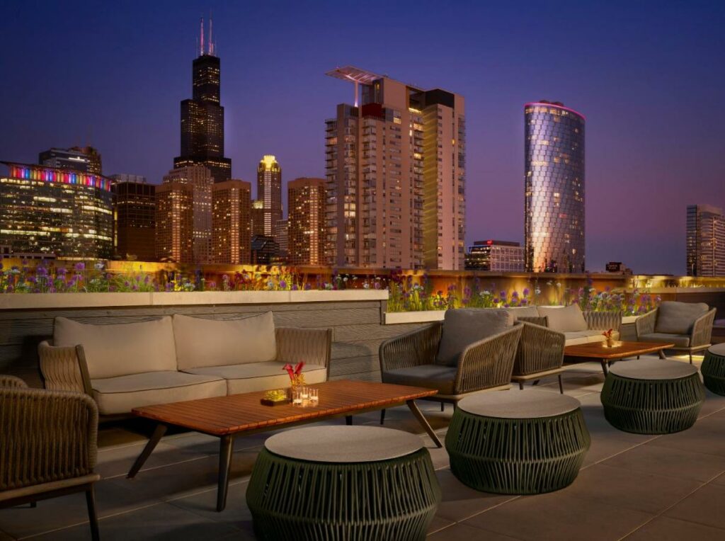 Rooftop terrace at the Nobu Hotel showing the Chicago skyline at dusk.