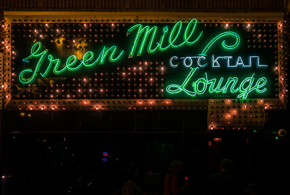 The neon green sign of the Green Mill Cocktail Lounge, a popular thing to do in Chicago at night