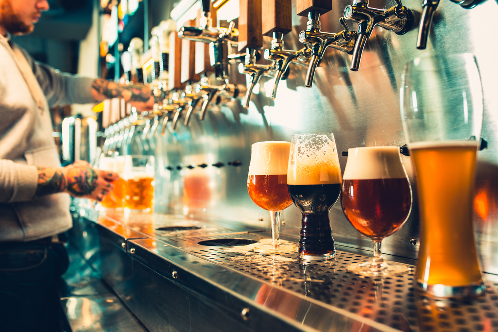 A large tap with several pints of beer under it and being poured, similar to what you'll see at some breweries in Chicago. 