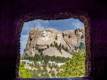 The view of Mount Rushmore through a tunnel on the Peter Norbeck Scenic Byway, one of the best things to do in Mount Rushmore.