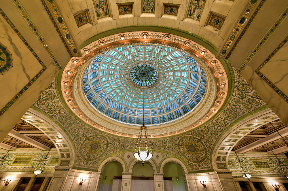 World's largest Tiffany glass dome ceiling in the Cultural Center in Chicago, Illinois. The ceiling is gold and the dome is ornate with blue glass