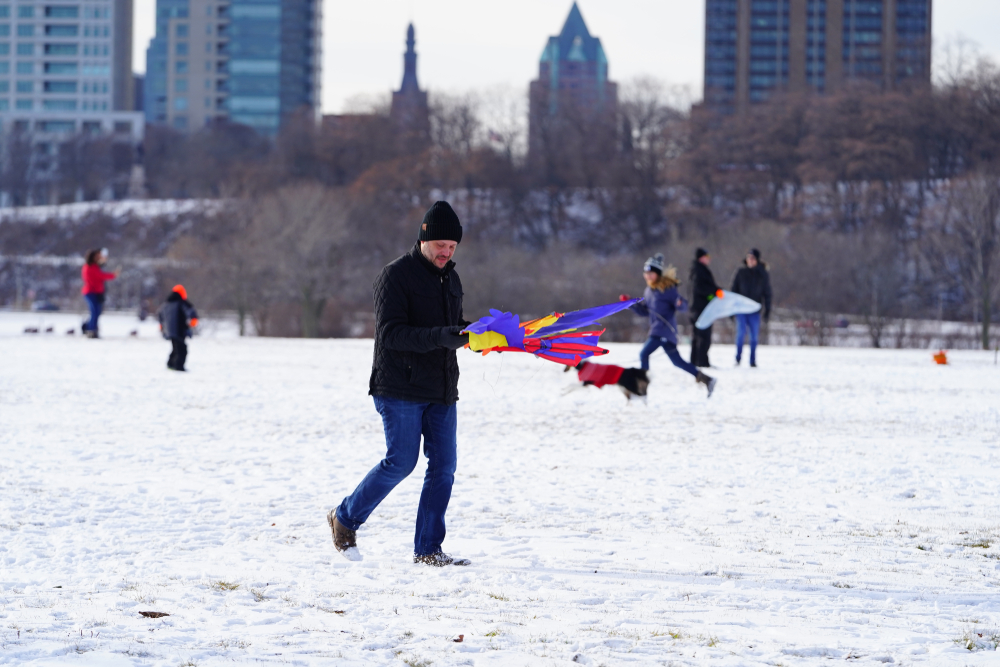 People walking on snow with colorful kites Wisconsin in winter