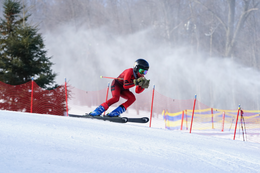 Man in red clothes skiing down the mountain Wisconsin in winter