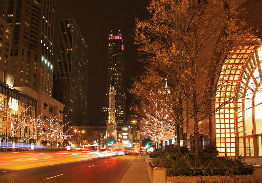 The Magnificent Miles lined with lit trees at night.