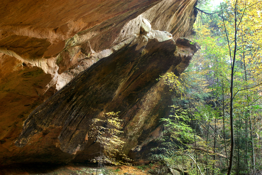 A rocky outcropping in the middle of the woods that is part of a cave in Ohio