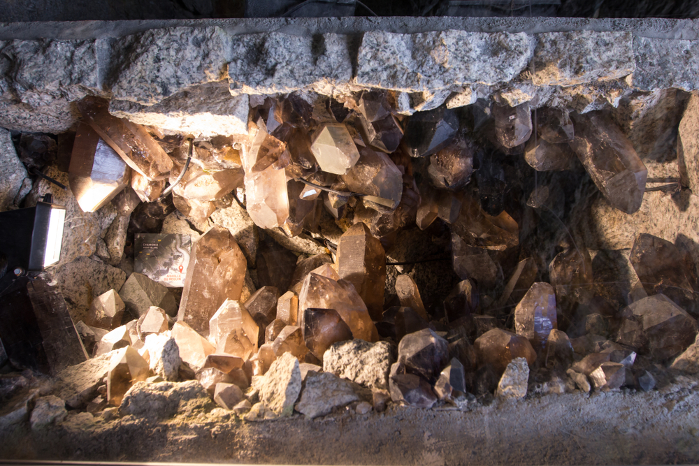 Unique crystal formations inside of a cave that are a smoky grey color