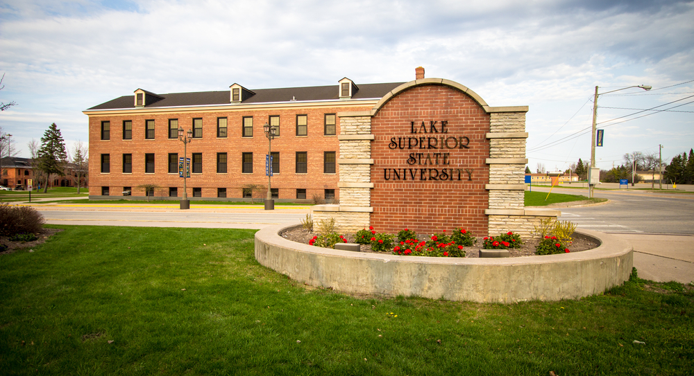 A sign at the entrance of the Lake Superior State University on a cloudy day