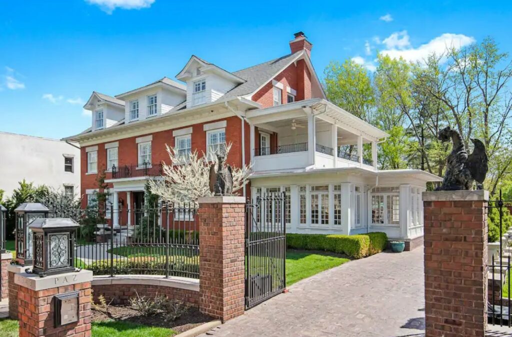 The exterior of a historic home with an iron gate around it, one of the best airbnbs in Kansas City Missouri