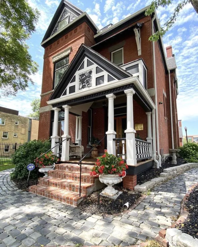 The front exterior of a historic home in Kansas City, Missouri that is brick and a Victorian