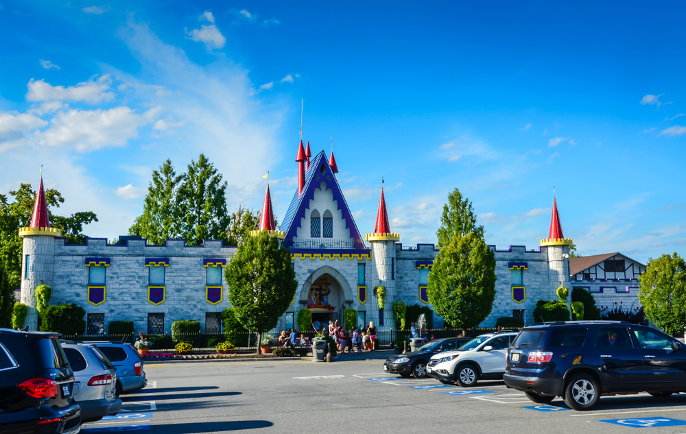 The entrance to Dutch Wonderland with cars infront. The entrance looks like a castle. 