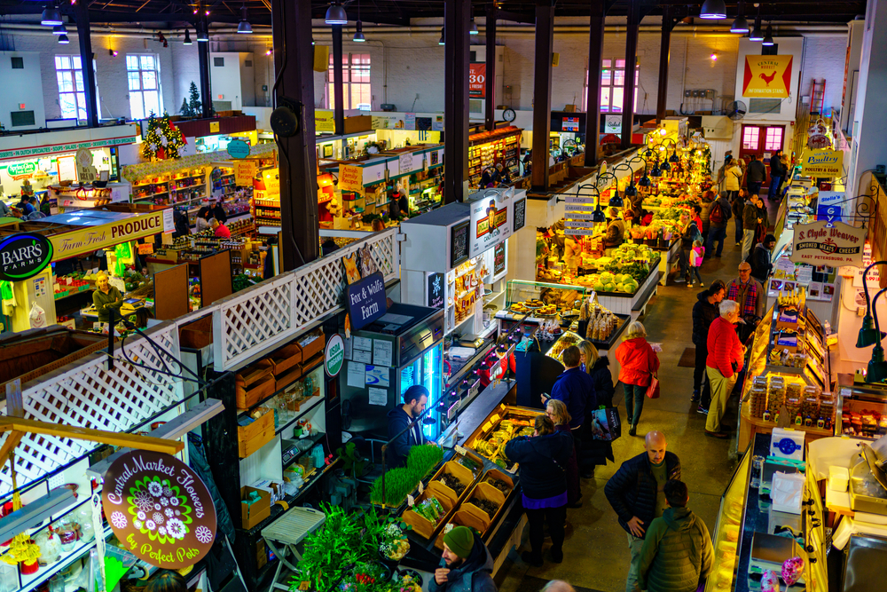 Standholder’s and shoppers actively engage in commerce at the city’s Central Market near Penn Square.