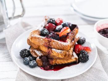 stack of french toast garnished with mixed berries brunch in chicago