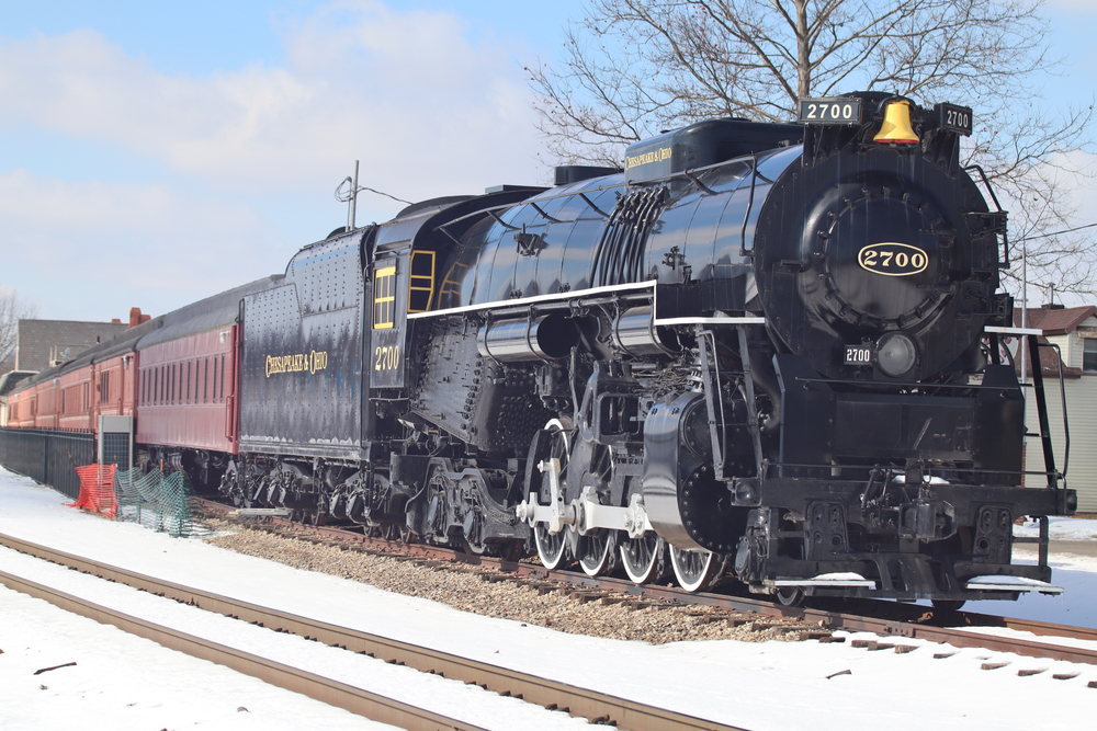 Black locomotive with snow in foreground, train rides in Ohio