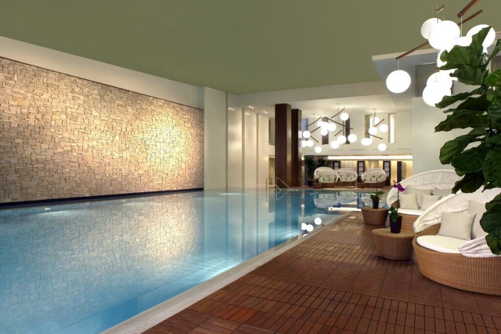 Classy indoor pool area with seating.