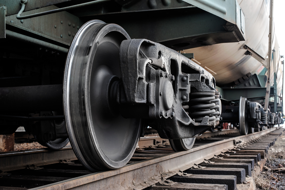 Close up of vintage train wheels on a track.